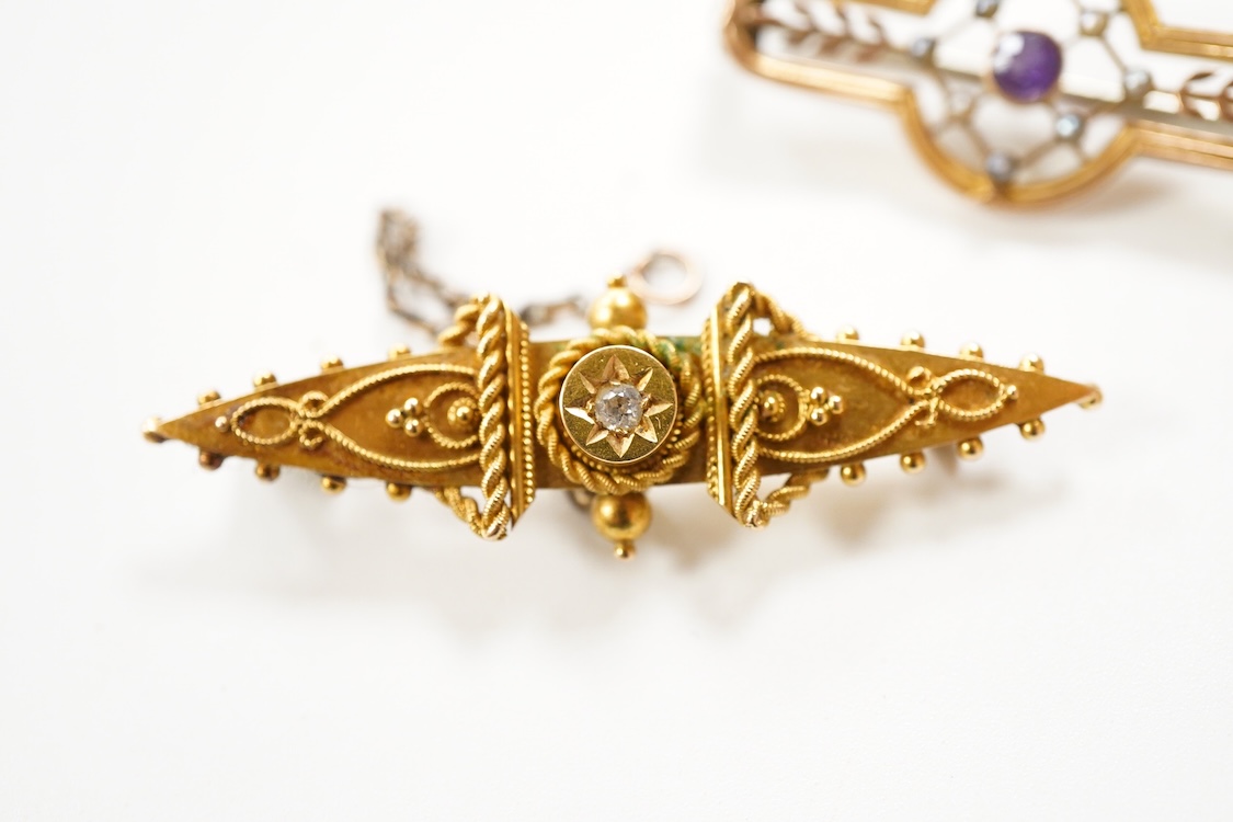 A Victorian 15ct and diamond set navette shaped Etruscan style brooch (lacking pin), 46mm, gross weight 3.5 grams, a 9ct, amethyst and seed pearl set bar brooch and a 9ct, garnet and split pearl set wreath brooch, gross